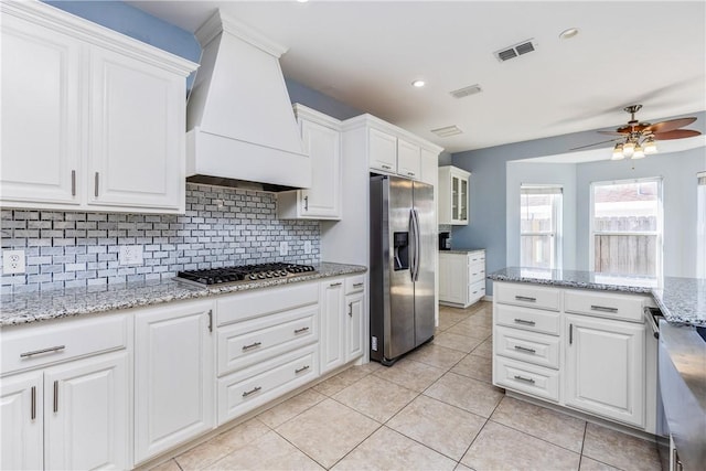 kitchen featuring stainless steel appliances, white cabinets, and custom exhaust hood