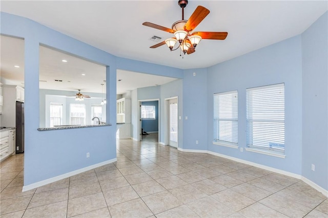 empty room with light tile patterned floors, recessed lighting, a ceiling fan, visible vents, and baseboards