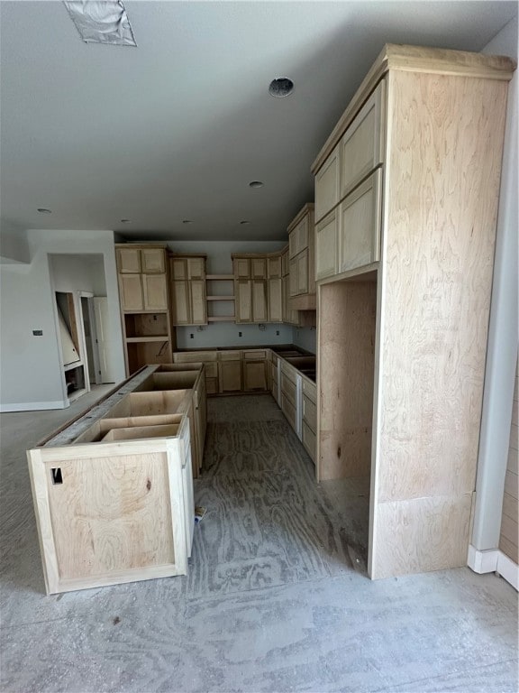 kitchen with a center island and light brown cabinetry