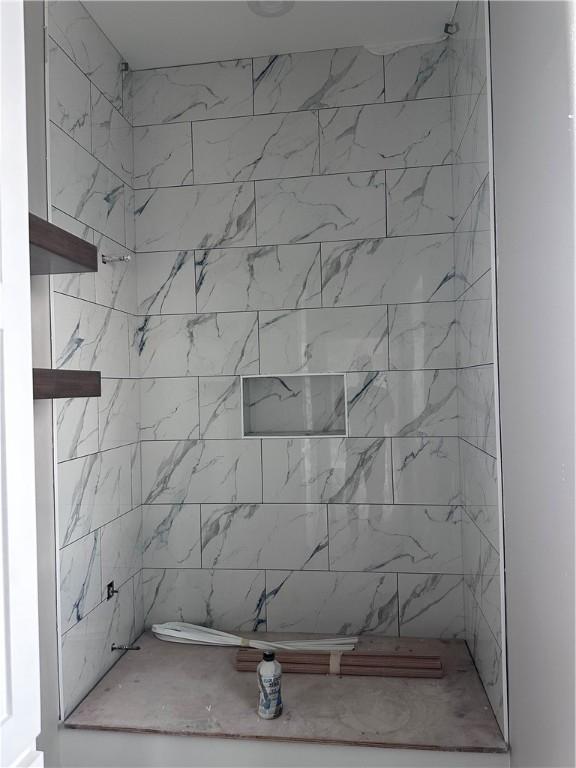 bathroom with a tile shower