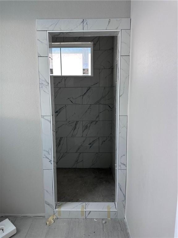 bathroom with a tile shower