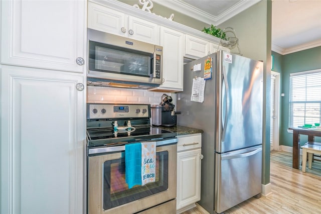 kitchen with decorative backsplash, white cabinetry, ornamental molding, and appliances with stainless steel finishes