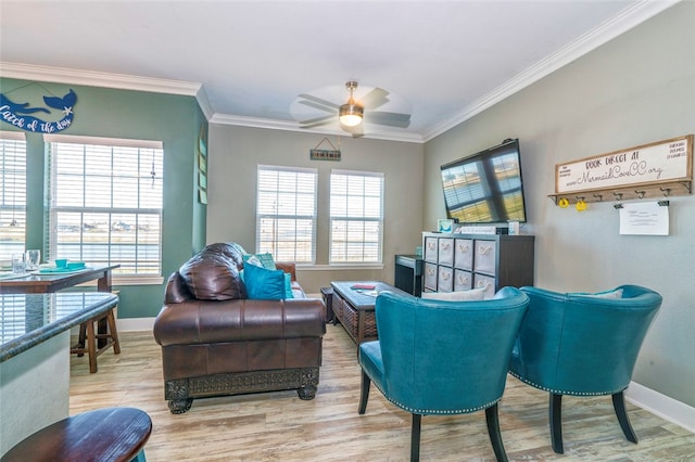 sitting room with ceiling fan and crown molding