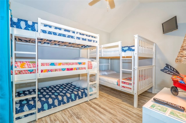 bedroom with hardwood / wood-style flooring, ceiling fan, and vaulted ceiling