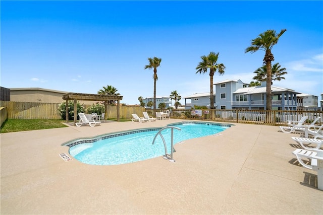 community pool with a pergola, fence, a patio, and a residential view