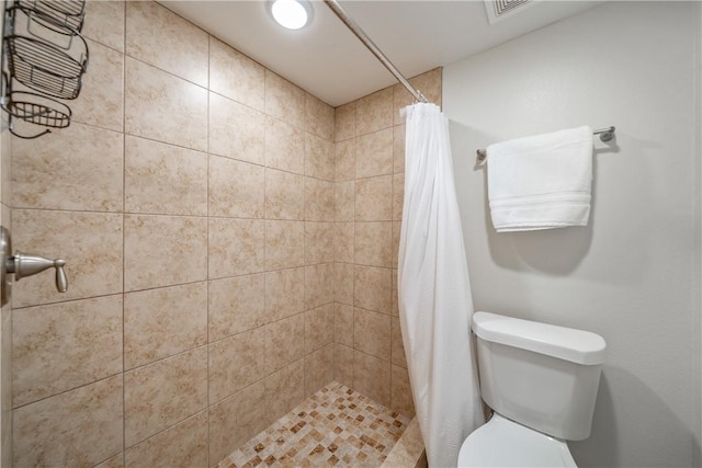 full bathroom with toilet, a shower stall, and visible vents