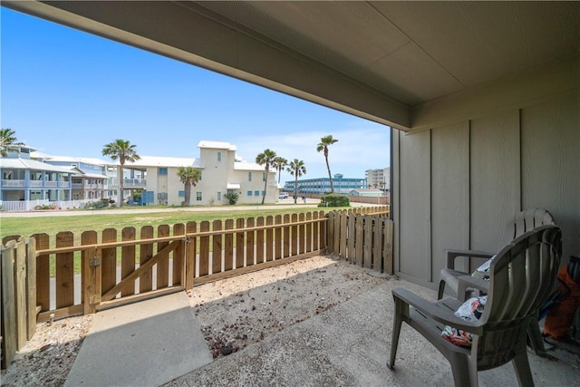 view of patio / terrace with fence and a residential view