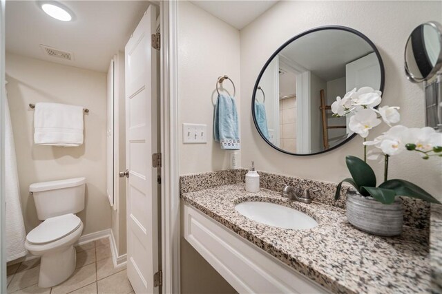 bathroom with toilet, tile patterned floors, vanity, and visible vents
