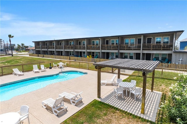 community pool with a lawn, a patio area, a gazebo, and fence