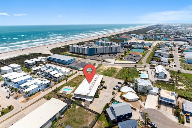 drone / aerial view with a water view and a beach view