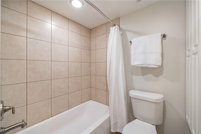 bathroom featuring toilet and shower / tub combo with curtain