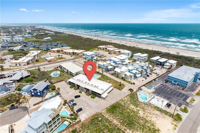 drone / aerial view with a water view and a view of the beach