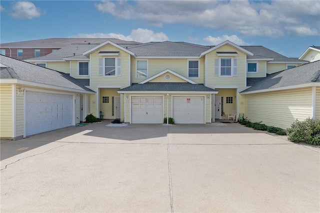 15102 Leeward Dr Unit 702, Corpus Christi, TX 78418 - townhome / multi-family property with concrete driveway, a garage, and roof with shingles