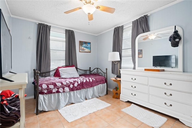 627 S Fuqua St, Rockport, TX 78382 - bedroom featuring multiple windows, ornamental molding, a textured ceiling, tile patterned floors, and ceiling fan