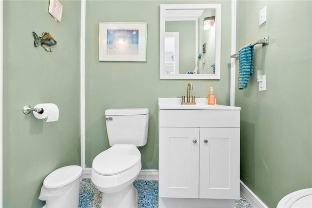 627 S Fuqua St, Rockport, TX 78382 - bathroom with toilet, vanity, and baseboards