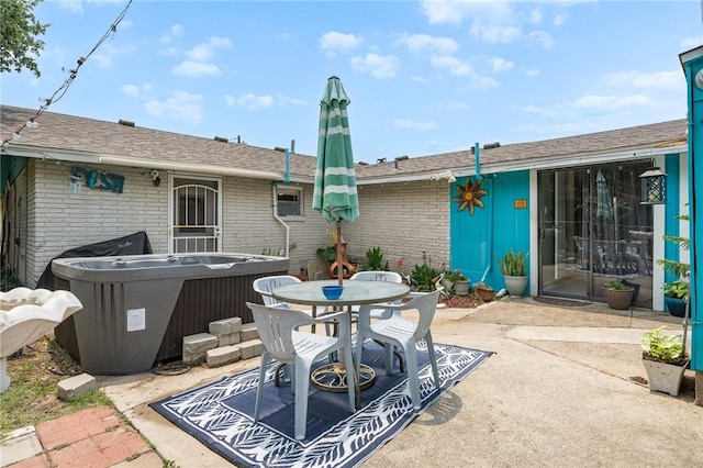 627 S Fuqua St, Rockport, TX 78382 - view of patio / terrace with a hot tub and outdoor dining area