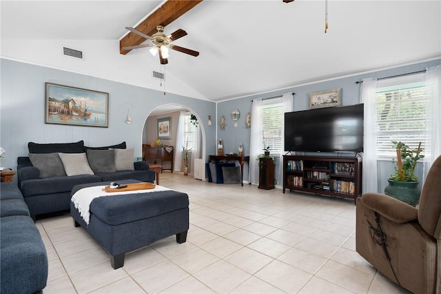 627 S Fuqua St, Rockport, TX 78382 - living area with ceiling fan, arched walkways, beam ceiling, light tile patterned flooring, and high vaulted ceiling