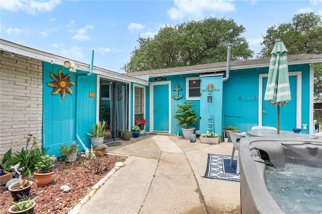 627 S Fuqua St, Rockport, TX 78382 - property entrance featuring a patio, outdoor dining space, and board and batten siding