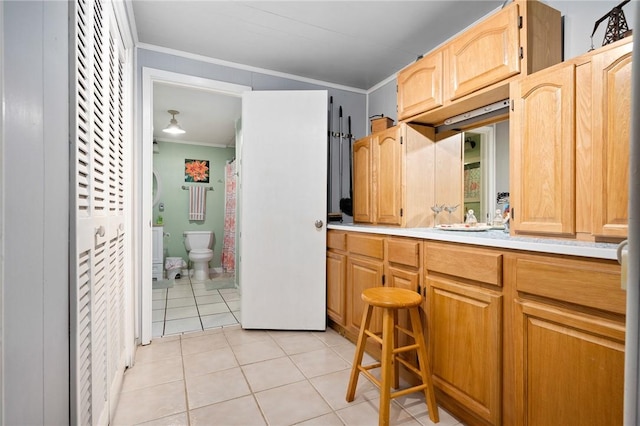 627 S Fuqua St, Rockport, TX 78382 - kitchen with crown molding, light countertops, and light tile patterned floors