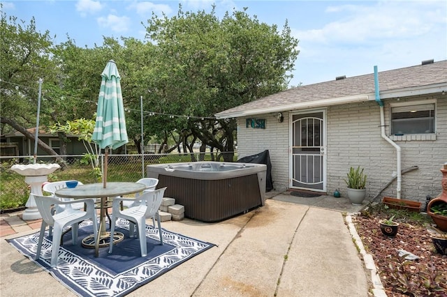 627 S Fuqua St, Rockport, TX 78382 - view of patio / terrace featuring a hot tub and outdoor dining space