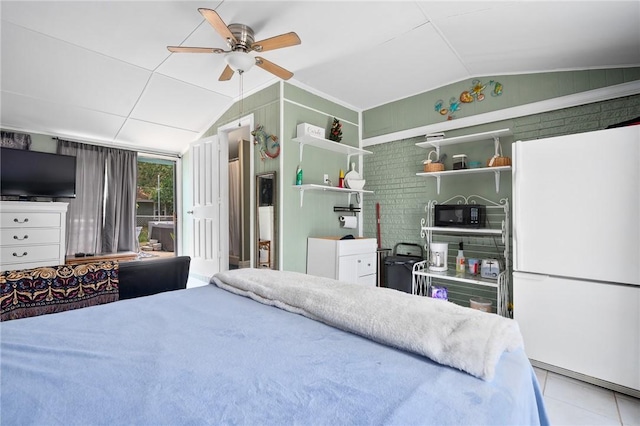 627 S Fuqua St, Rockport, TX 78382 - bedroom with lofted ceiling, freestanding refrigerator, tile patterned floors, a ceiling fan, and access to outside