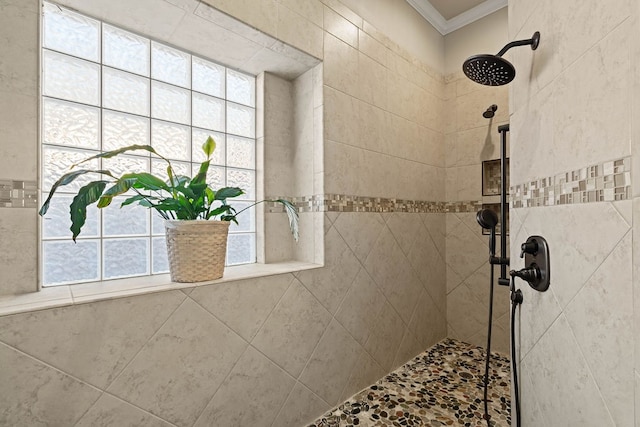 bathroom with crown molding and tiled shower