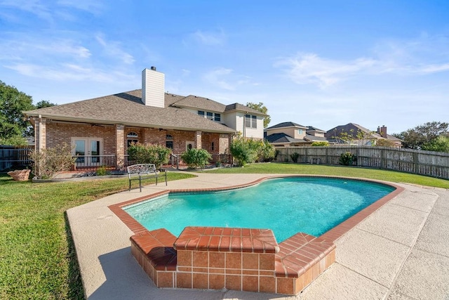 view of swimming pool featuring a patio, a yard, and french doors