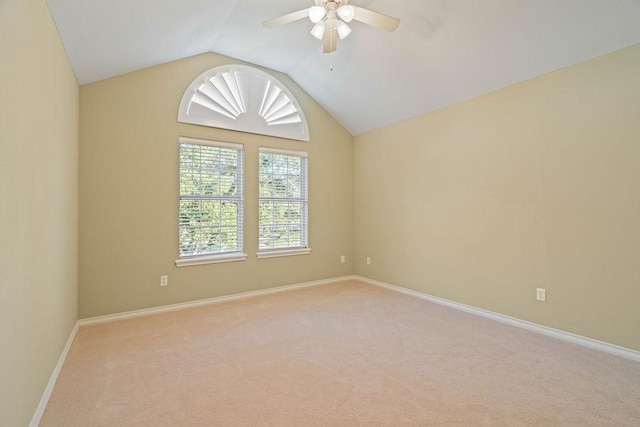 carpeted spare room with vaulted ceiling and ceiling fan