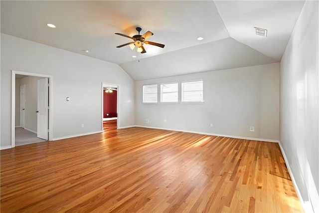 unfurnished room featuring lofted ceiling, light hardwood / wood-style floors, and ceiling fan