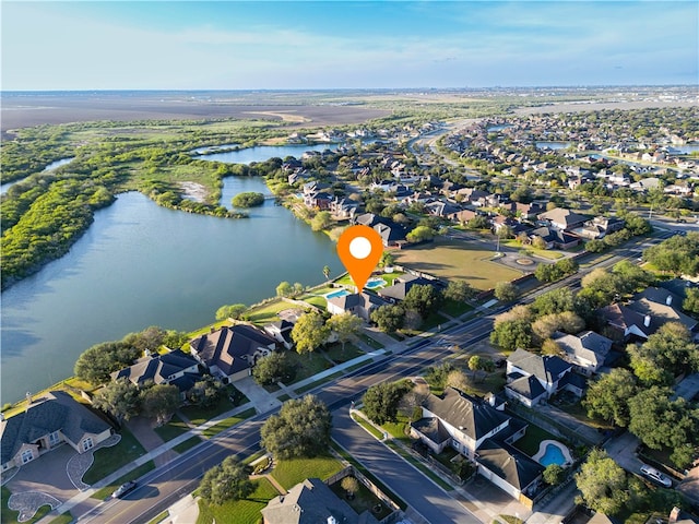 birds eye view of property with a water view