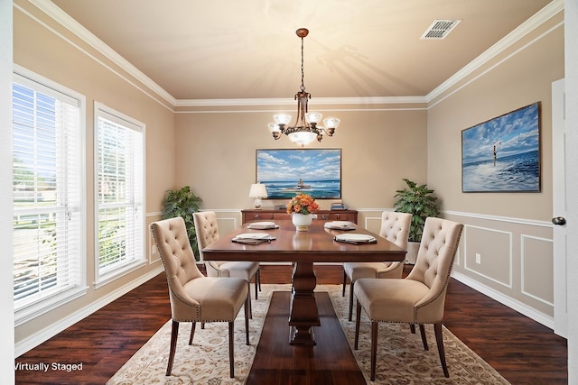 dining room with dark hardwood / wood-style flooring, a notable chandelier, and ornamental molding