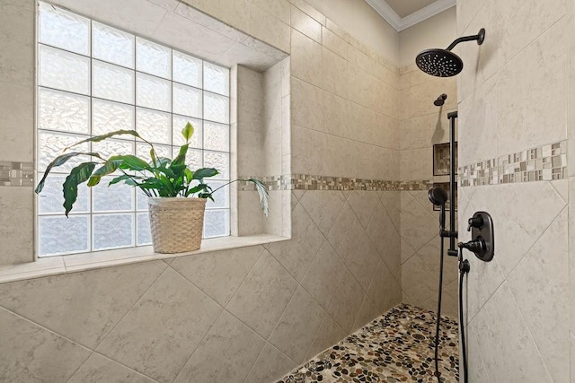 bathroom featuring a tile shower and crown molding