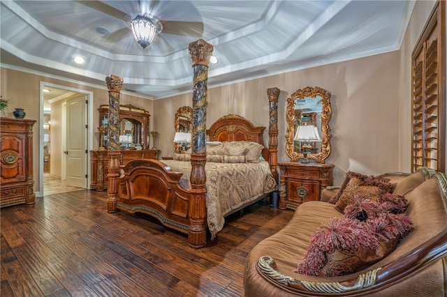 bedroom featuring dark wood-type flooring, a tray ceiling, ceiling fan, and crown molding