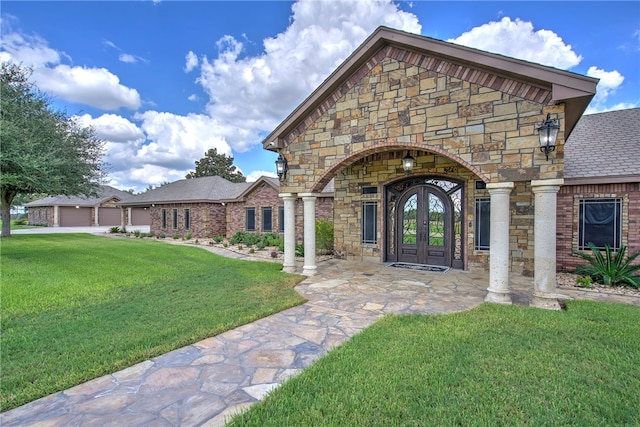 property entrance featuring french doors and a lawn