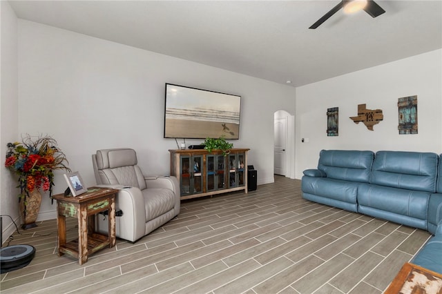 177 Glenvalley Cir, Bandera, TX 78003 - living area with arched walkways, baseboards, light wood finished floors, and ceiling fan