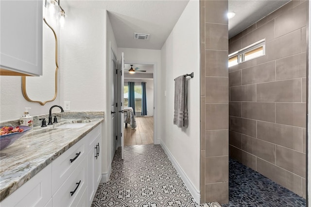 177 Glenvalley Cir, Bandera, TX 78003 - full bathroom featuring a ceiling fan, visible vents, baseboards, tile patterned flooring, and vanity