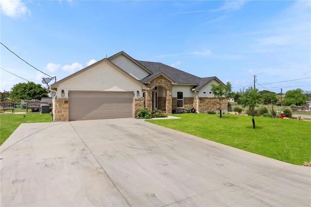177 Glenvalley Cir, Bandera, TX 78003 - ranch-style home with stone siding, an attached garage, stucco siding, a front yard, and driveway