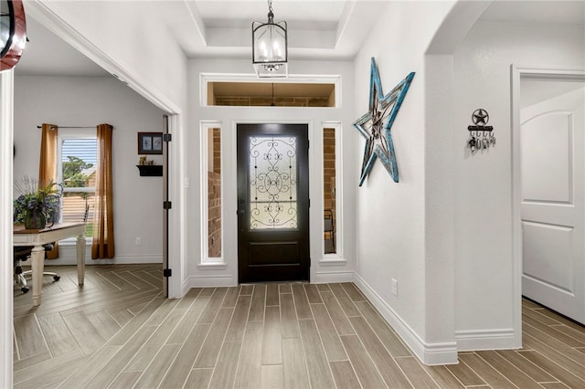 177 Glenvalley Cir, Bandera, TX 78003 - foyer with a tray ceiling, wood finished floors, baseboards, and arched walkways