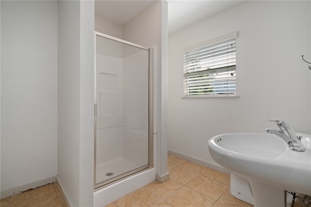 bathroom featuring walk in shower, tile patterned flooring, and sink