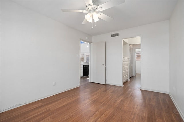 unfurnished bedroom featuring ceiling fan and dark hardwood / wood-style floors