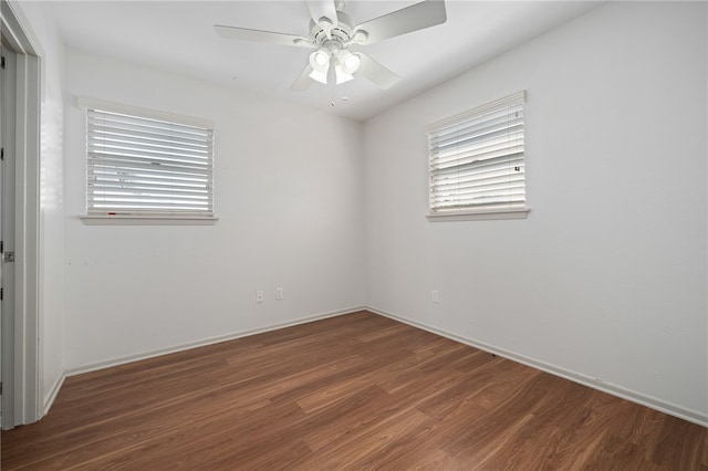 unfurnished room with ceiling fan and dark hardwood / wood-style floors