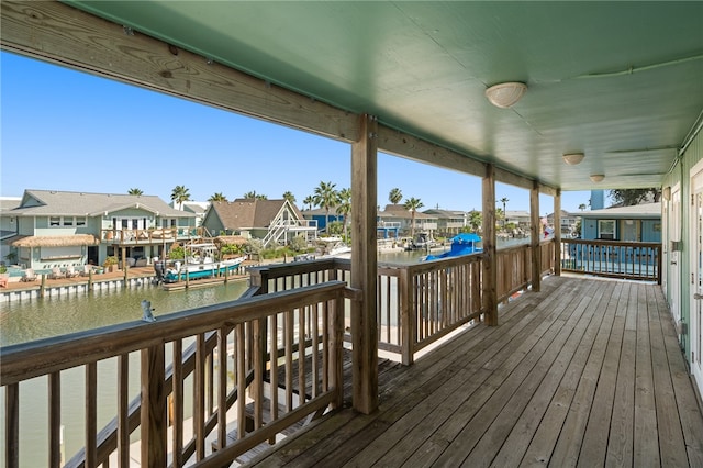 wooden terrace featuring a water view and a boat dock