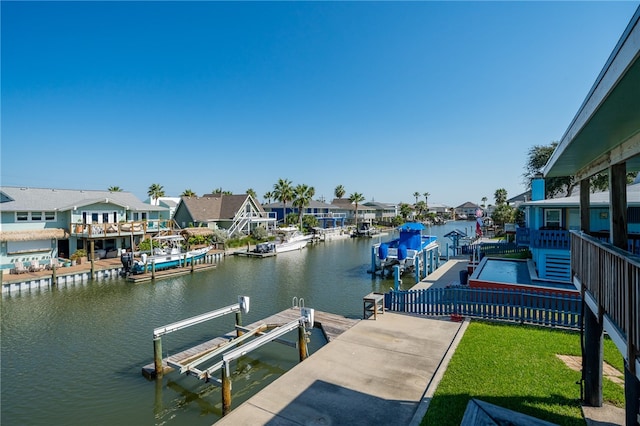 dock area featuring a lawn and a water view