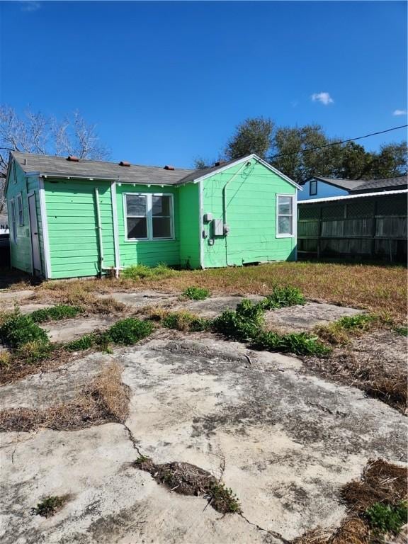 back of house with fence