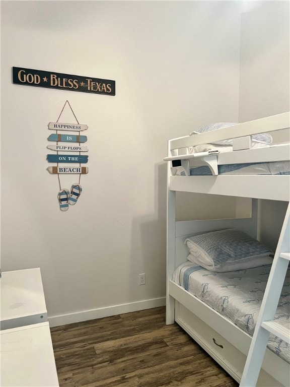 bedroom with dark hardwood / wood-style flooring