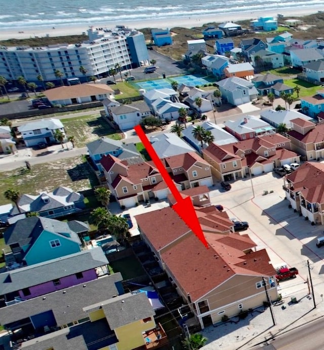 birds eye view of property featuring a beach view and a water view