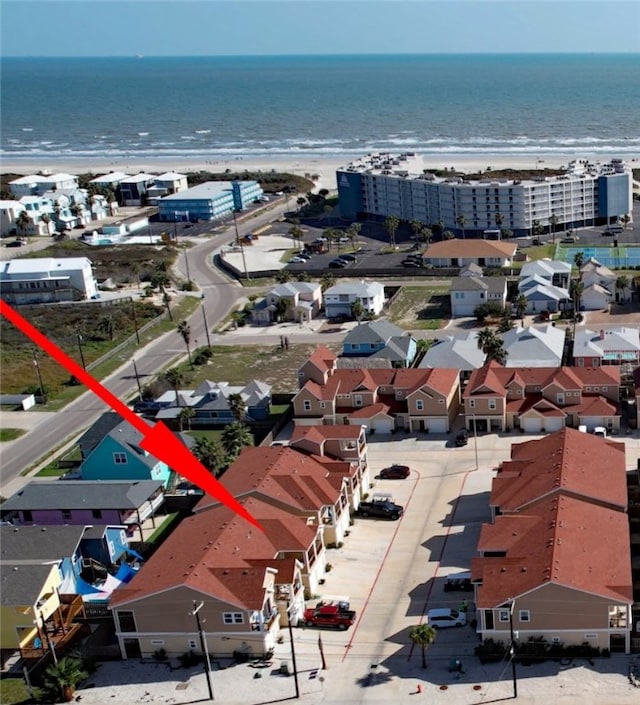 birds eye view of property with a beach view and a water view