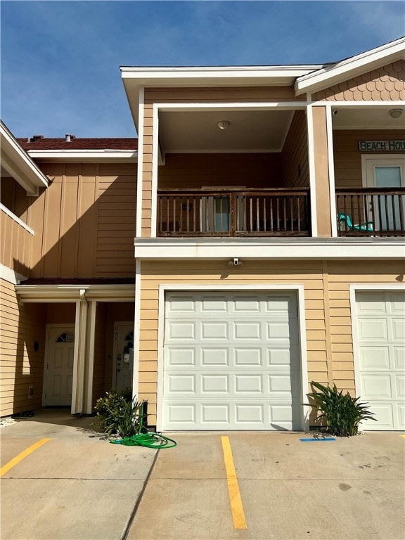 exterior space featuring a garage and a balcony