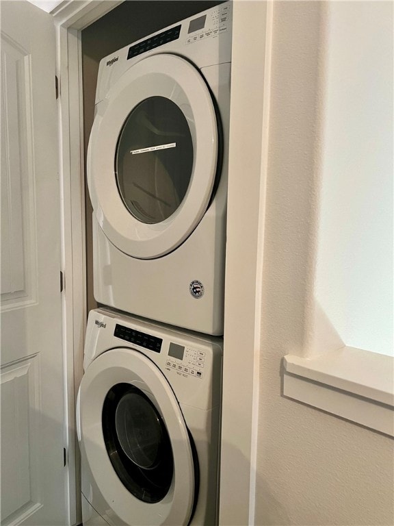 laundry room with stacked washing maching and dryer