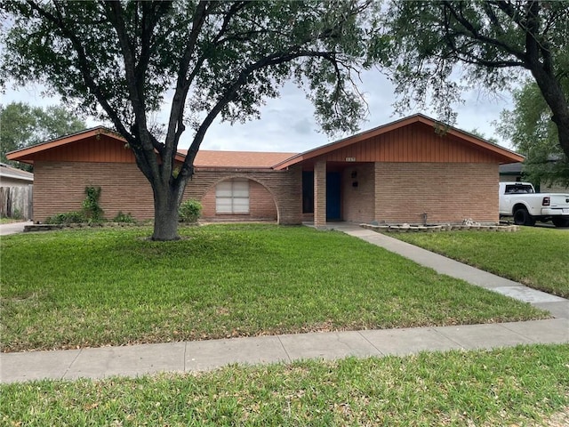 ranch-style house with brick siding and a front yard